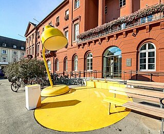 Rathaus mit großer gelber Lampe davor