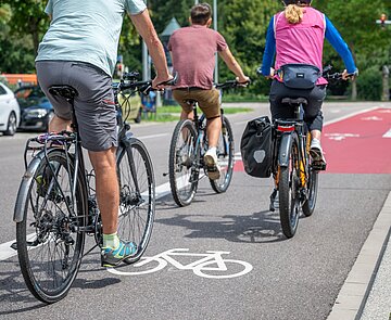 Drei Radfahrer auf Radfahrstreifen unterwegs