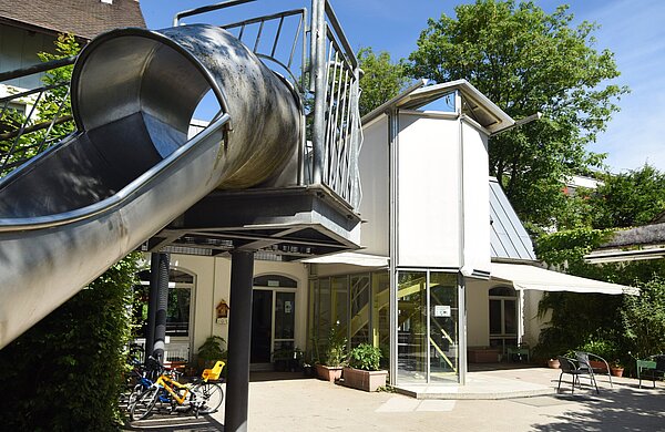 Kindertagesstätte Lußstraße Gebäudeansicht mit Rutsche im Vordergrund