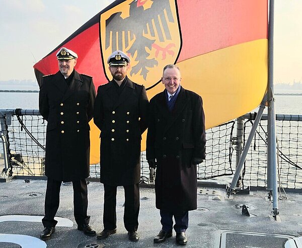 Neuer Kapitän auf der KARLSRUHE: Markus Jonas (Mitte) mit Geschwaderkommandeur Tippner und BM Käuflein. Foto: HA/Wilhelm 