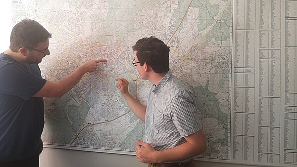 Zwei Personen betrachten eine Stadtplan.