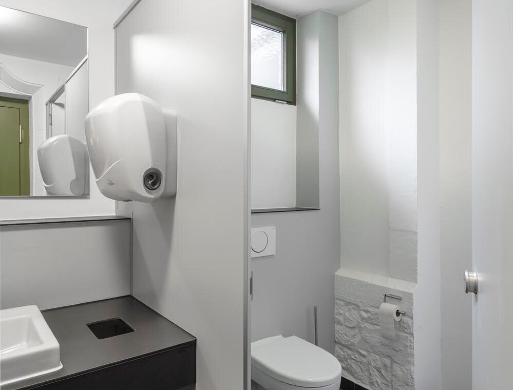 Moderne Sanitärobjekte in weiß und dunkle Bodenfliesen