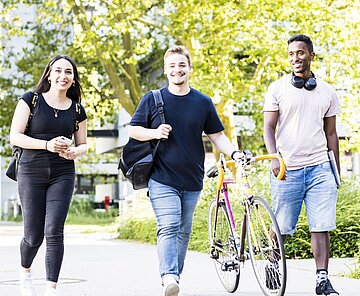 Studierende schlendern über den Campus
