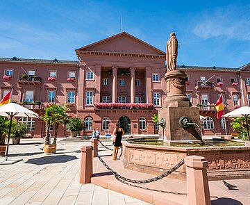 Außenansicht des Rathausgebäudes am Marktplatz mit Brunnen im Vordergrund
