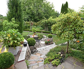 Blick von Terasse auf einen grünen Garten