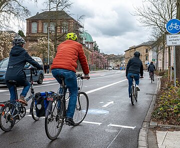 Verkehrssituation Radroute 12 mit Radfahrenden auf Radfahrstreifen und KFZ Verkehr