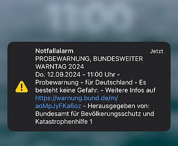 Screenshot eines iPhone-Bildschirms mit Probewarnung des Bundesamts für Bevölkerungsschutz und Katastrophenhilfe