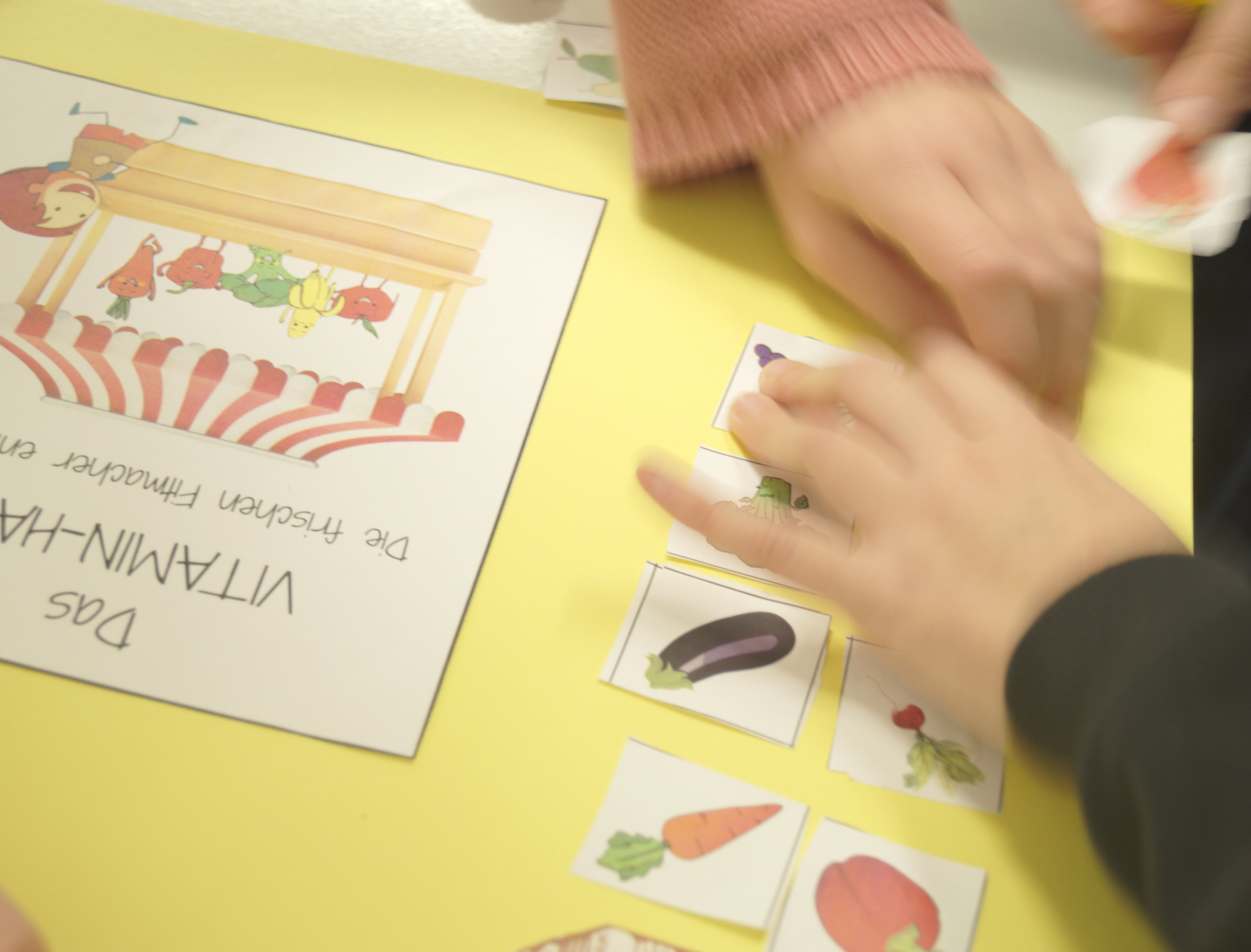 Kinder basteln ein Plakat zum Thema Obst und Gemüse