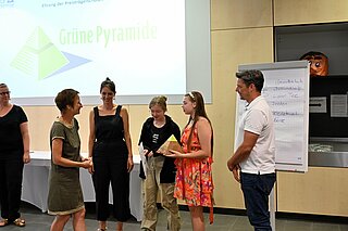 Schülerinnen und Lehrkäfte des Lessing Gymnasium nehmen die Grüne Pyramide in der Kategorie "Umwelt & Faire Welt" entgegen.